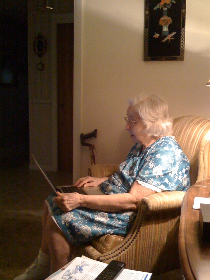 My grandmother on my laptop, looking at photos of the kids